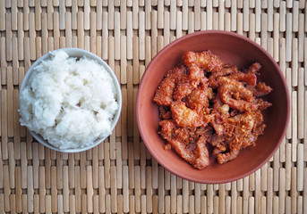 Jiang Hay or Chiang Rai pork stir fried with garlic and peppercorns with glutinous sticky rice