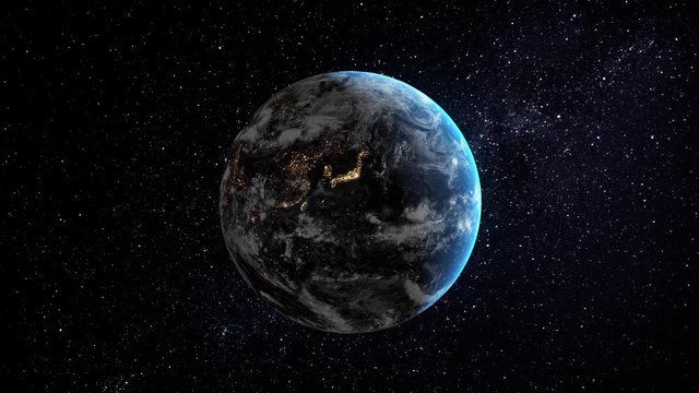 Asian city lights from the space and sunrise. The earth slowly rotating in space  with the lights of the planet's cities visible on the surface. 