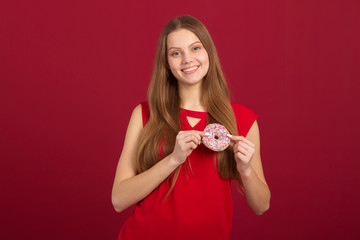 beautiful young woman with her hair on a red background with donuts