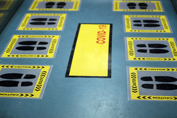 Signs or symbols to stand in the designated area to prevent the spread