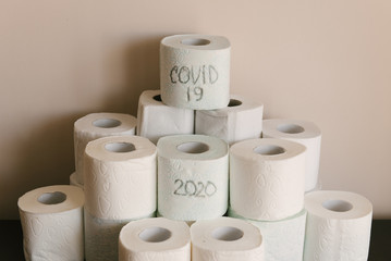 Toilet paper roll background with text toilet paper to 1 package per household. Concept of lack of toilet paper in stores due to coronavirus, Covid-19, hygiene, panic.