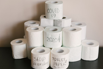 Toilet paper roll background with text toilet paper to 1 package per household. Concept of lack of toilet paper in stores due to coronavirus, Covid-19, hygiene, panic.