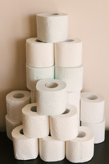 Toilet paper roll background with text toilet paper to 1 package per household. Concept of lack of toilet paper in stores due to coronavirus, Covid-19, hygiene, panic.