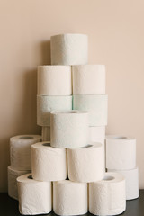 Toilet paper roll background with text toilet paper to 1 package per household. Concept of lack of toilet paper in stores due to coronavirus, Covid-19, hygiene, panic.