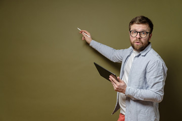 Discussion of the project. Concentrated man with a tablet in hand tells his idea and shows with a...