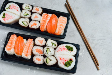 sushi and rolls takeaway food. takeout set rolls and sushi food delivery. set with salmon and shrimp. service food order online during the COVID-19 coronavirus quarantine