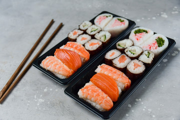sushi and rolls takeaway food. takeout set rolls and sushi food delivery. set with salmon and shrimp. service food order online during the COVID-19 coronavirus quarantine