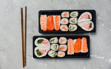 food delivery. set of sushi and rolls with salmon and shrimp. service food order online and home delivery during the COVID-19 coronavirus quarantine . concept layout 2 for the price of 1.