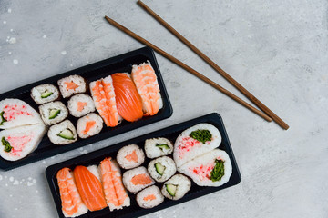 food delivery. set of sushi and rolls with salmon and shrimp. service food order online and home delivery during the COVID-19 coronavirus quarantine . concept layout 2 for the price of 1.