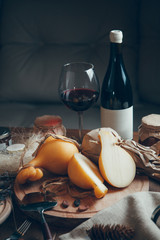 Composition of cheese with wine and honey. Caciocavallo cheese on a wooden Board.