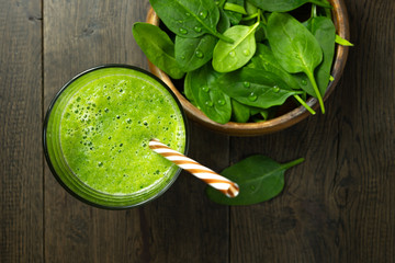 spinach smoothies in glass is on table