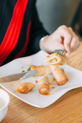 Fried pancakes with honey and cheese. The girl has dessert in the restaurant.