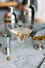 An empty glass of olive. A glass of white and wine in the restaurant.