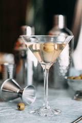 An empty glass of olive. A glass of white and wine in the restaurant.