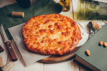  Round pastry with cheese and decor. Khachapuri in Megrelian on a wooden Board.