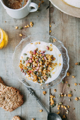 Healthy natural Breakfast. Flatley with modern food and honey. Granola with yogurt on a plate.