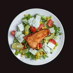 Fresh healty green salad, with tomatoes, lime, feta and salmon