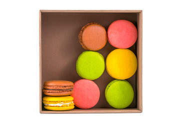 colored macaroons in boxes on a white background