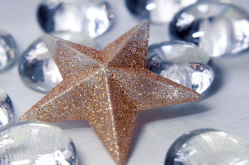 Interior decoration - a golden star on a background of transparent glass stones, photographed close-up