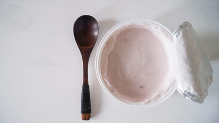 Blueberry yogurt on a white wooden table. Fresh yogurt. Healthy eating concept. High Resolution Product. View from above