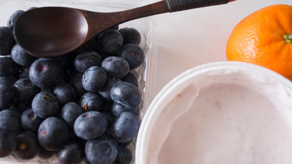 Blueberry yogurt on a white wooden table. Fresh yogurt. Healthy eating concept. High Resolution Product. View from above