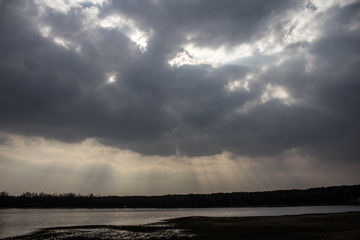 Bright sky with sunbeams over the lake. Beautiful landscape.