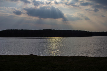 Bright sky with sunbeams over the lake. Beautiful landscape.