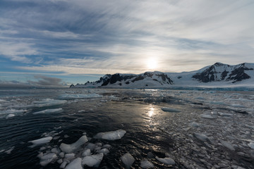 Sunrise on mountains in Antarctica from water level