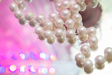 The opposite of the pearls is in the mirror . iron pink cage . ball pearls for jewelry making spread out on the surface of the mirror.