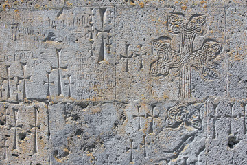 A wall of tuff stone carved with a cross - Khachkars