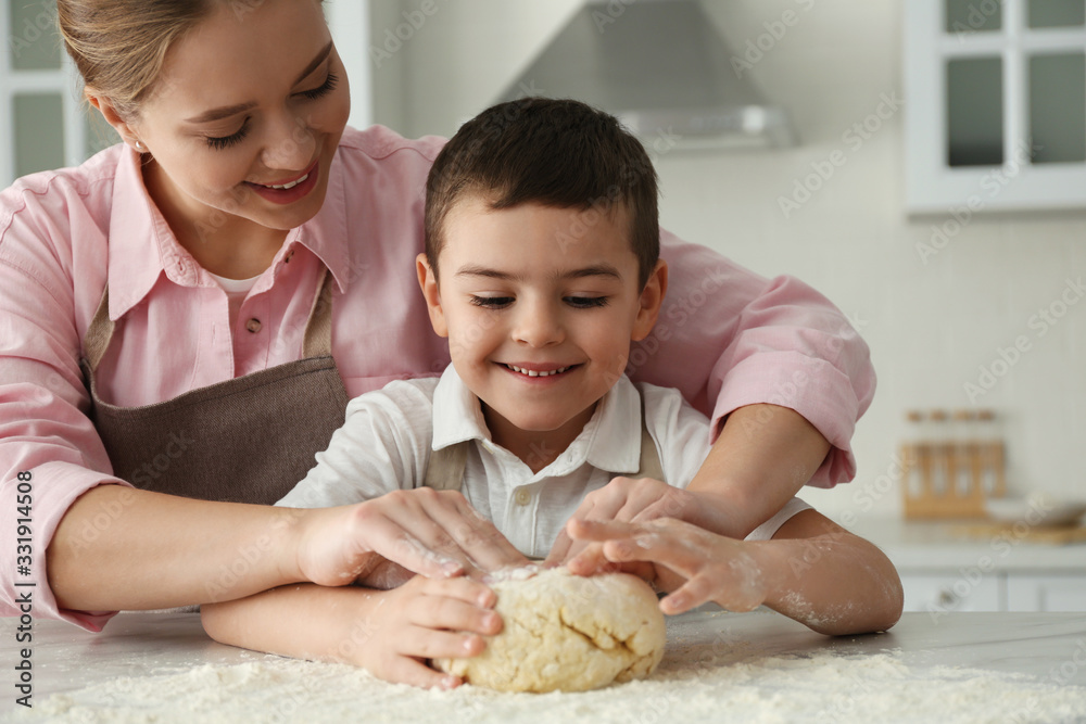 Poster Mother and son cooking together in kitchen