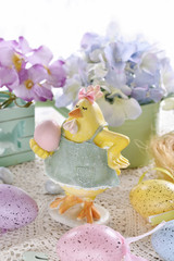 easter card with funny hen figurine  and colorful eggs