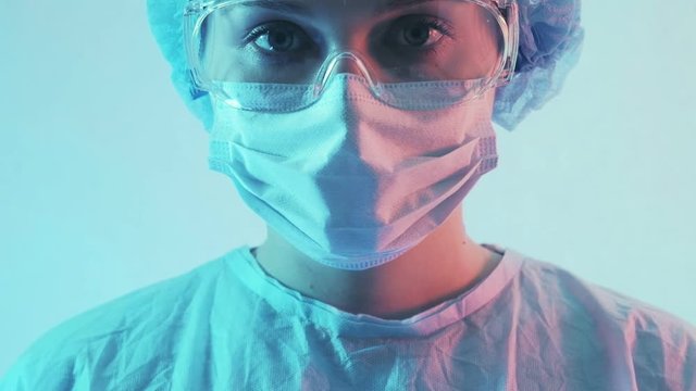 Pandemic virus outbreak. Doctor portrait. Female medical worker in protective face mask goggles.