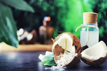 Coconut on a dark stone table. Coconut oil.