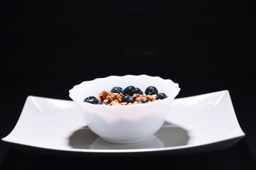 A healthy breakfast cereal with milk and fruit. Oat and corn flakes with chocolate and yogurt. The concept of healthy and vegetarian food.