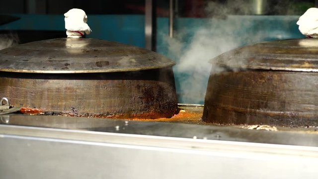 Traditional iron cooking pot boiling beef bone broth at Korean restaurant