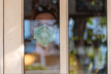 An Asian female keeps herself in quarantiine at home to prevent Corona Virus infection and keeping social distancing form other people