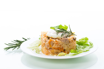 boiled rice with vegetables and fried egg with salad leaves in a plate