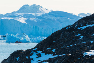 Tourist ship in Ilulissat Icefjord in front of glacier