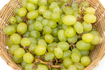 Fresh green grape in basket isolated on white with clipping path. Full depth of firld