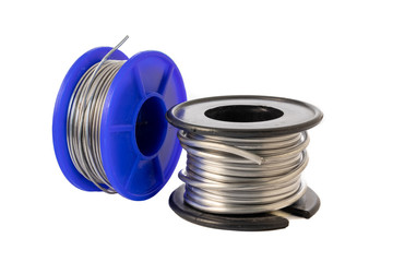 Solder wire spools made of tin and lead isolated on a white background