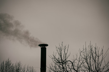 Smoke coming out from chimney against sky.