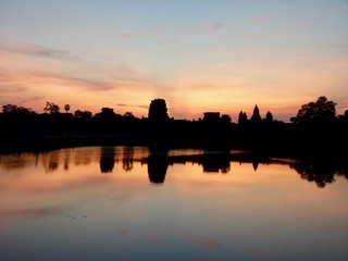 Fototapeta na wymiar Angkor Wat during sunrise, shadows before lake with reflections, ruins of Angkor, Cambodia