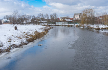 Obraz premium Winter landscape with half-frozen Sura river in Novo-Oleksadrivka village near Dnipro city, Ukraine