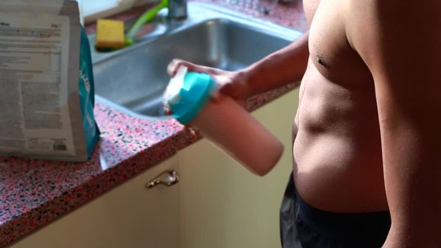 male preparing whey protein for breakfast