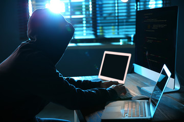 Hacker with computers in dark room. Cyber crime