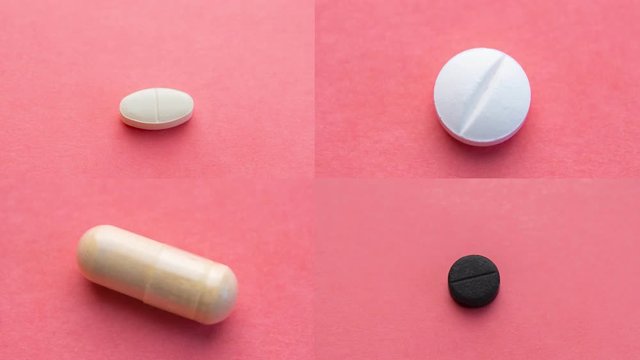 Different pills sequence. Stopmotion of few different pills on pink background