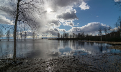 sunny landscape with lake, cloud glare in water