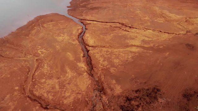 Red soil with reflections in Blue River Provincial Park in New Caledonia.
