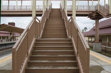High stairs to bridge for railway crossing at train station